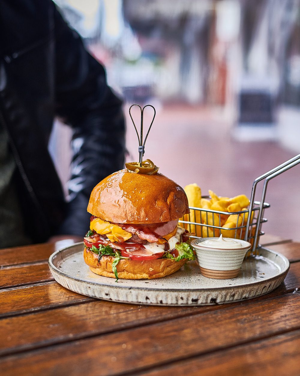 Wagyu burger with chips at an outdoor table at Black Drop, Black Rock