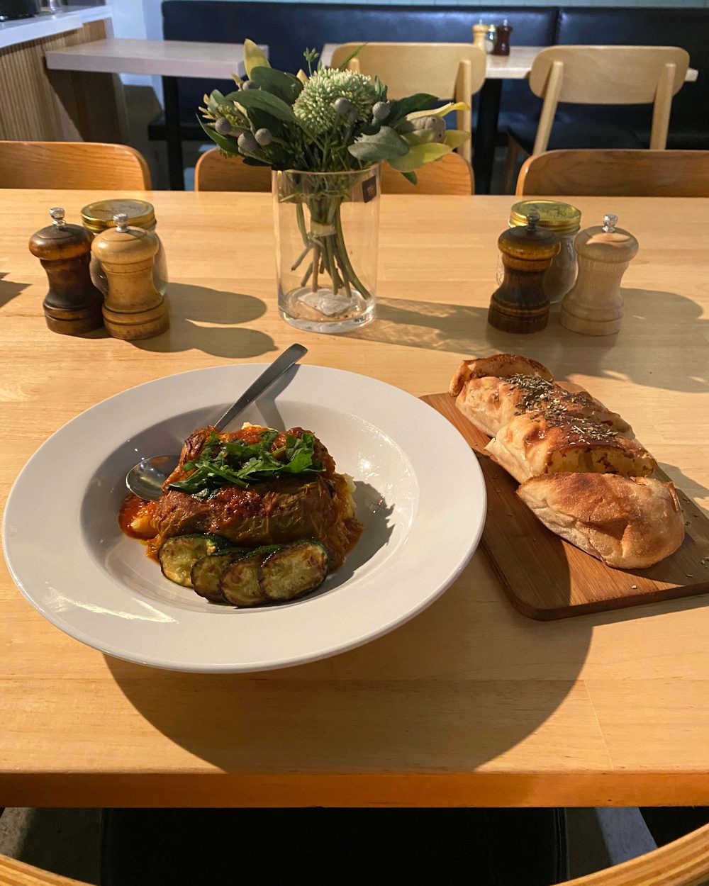 Stuffed cabbage rolls in tomato sauce with grilled zucchini and bread at Black Drop, Black Rock