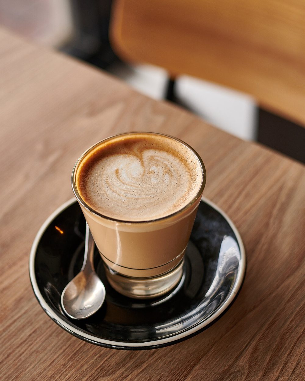 Latte beside a Reserved sign at Black Drop cafe, Black Rock